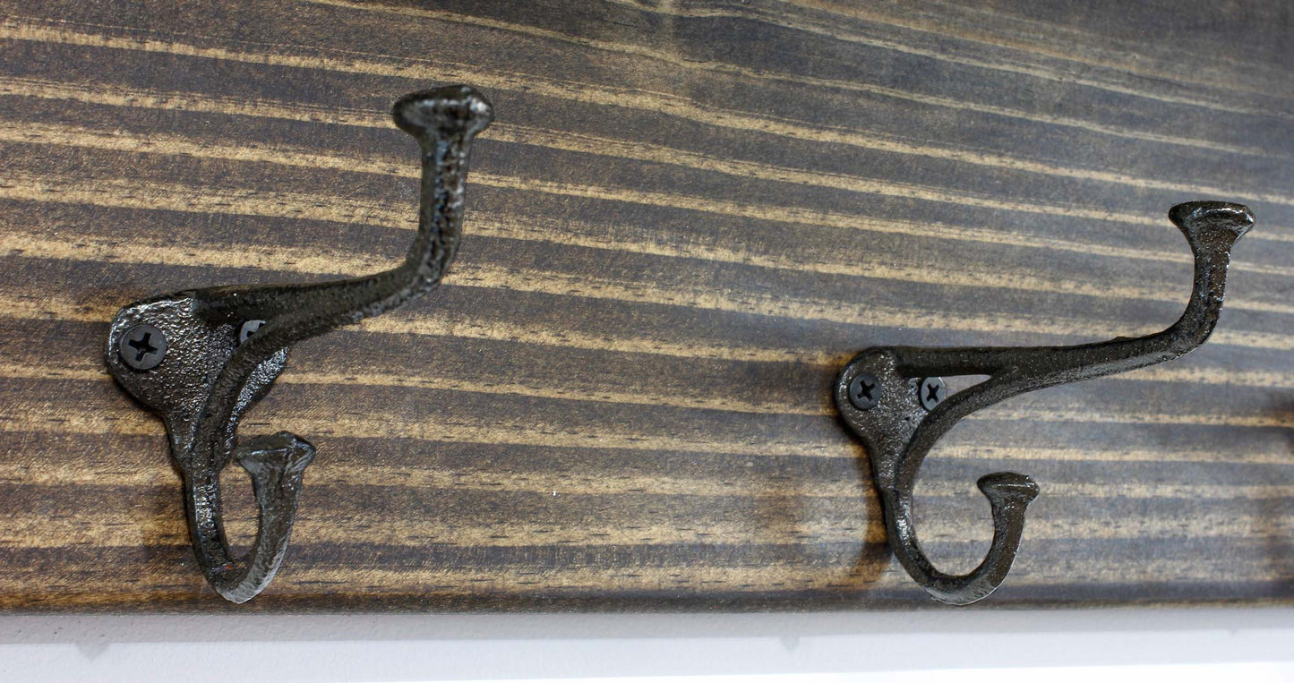 close up of the nailhead metal hook hangers have an early american blacksmith vintage look for a farmhouse decor home or office