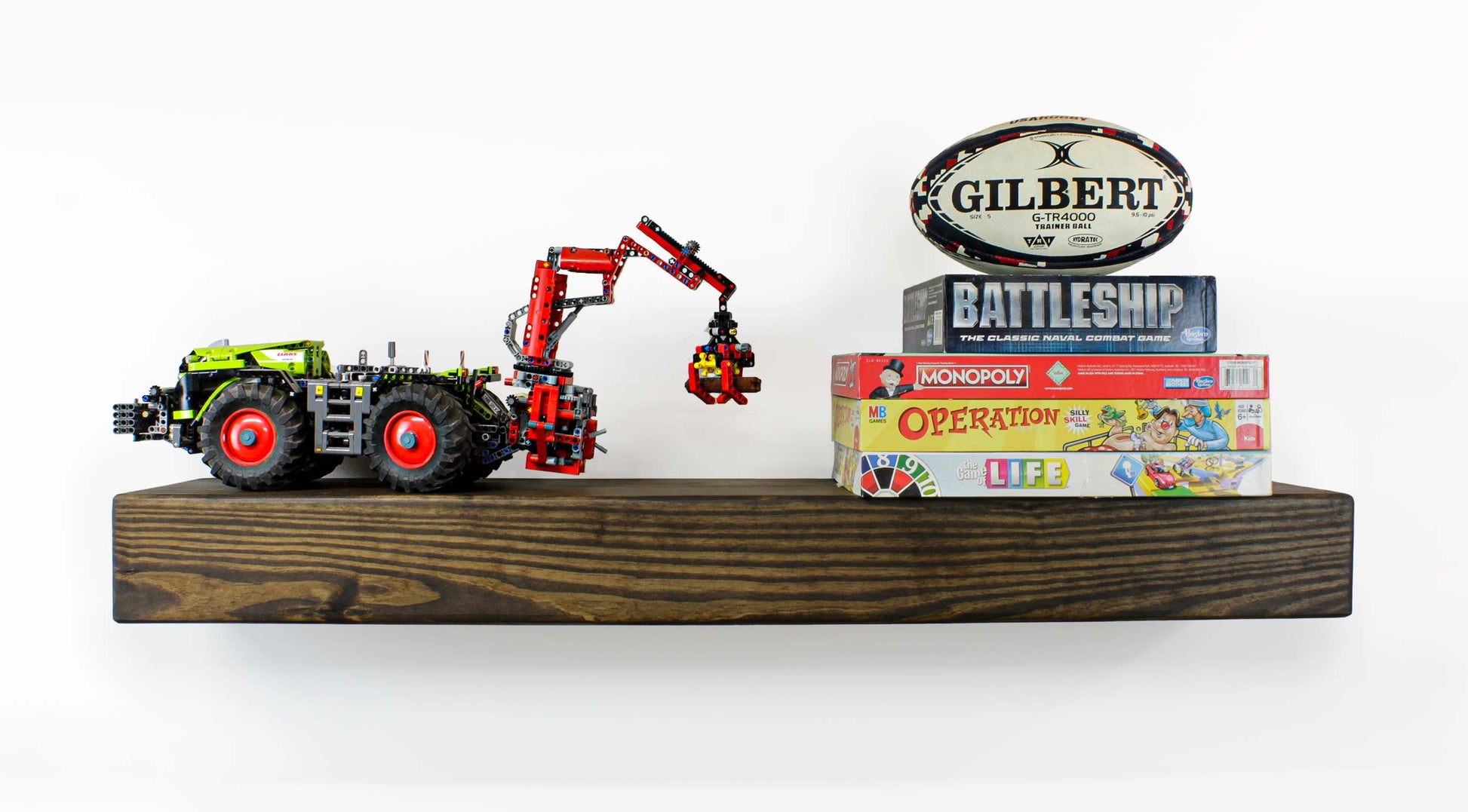 game room shelf for board games and large toys to display and store neatly great for kids rooms and guest rooms as the shelf is sturdy and well secured to the wall with a dental insert. Works well in a man cave because the thick large wooden beam has a masculine decor vibe. Rustic Shelves Floating Wall Shelf Wooden Pine Timber Beam Farmhouse man cave, guest room or fun family room with toys and games