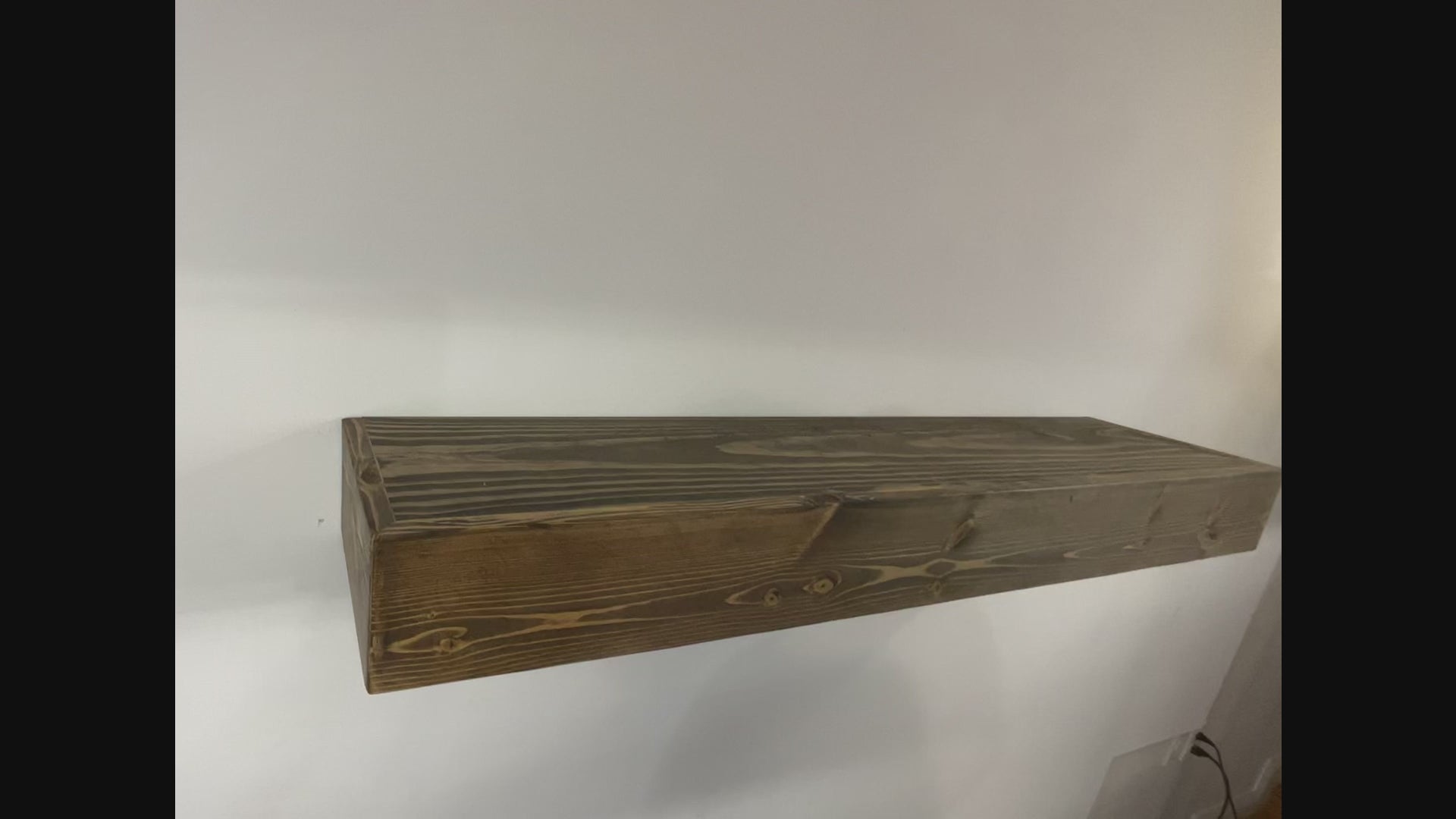 demonstration of the timber beam shelf being hung over the dental insert