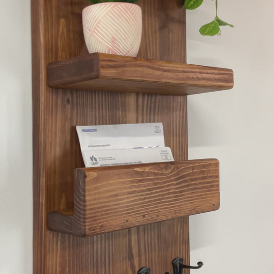 After checking your mailbox you can leave your mail in the holder until you are ready to sort it. The two shelves conveniently hold sunglasses, home decor, holiday decor, welcome signs, pictures, postcards, small plants, or air fresheners to keep your entryway or mudroom neat, tidy and cheerful. You won't forget your things as you leave your home or office. Four small metal double hooks in a row along the bottom of the wooden mail holder to hang keys or dog leashes on for convenient storage. 