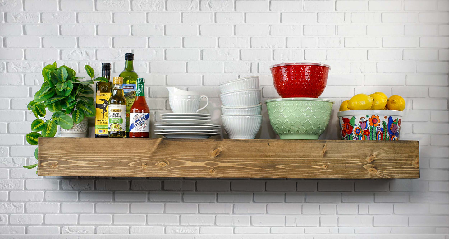 Kitchen wall mounted floating Wooden shelf with kitchen items against a white brick wall